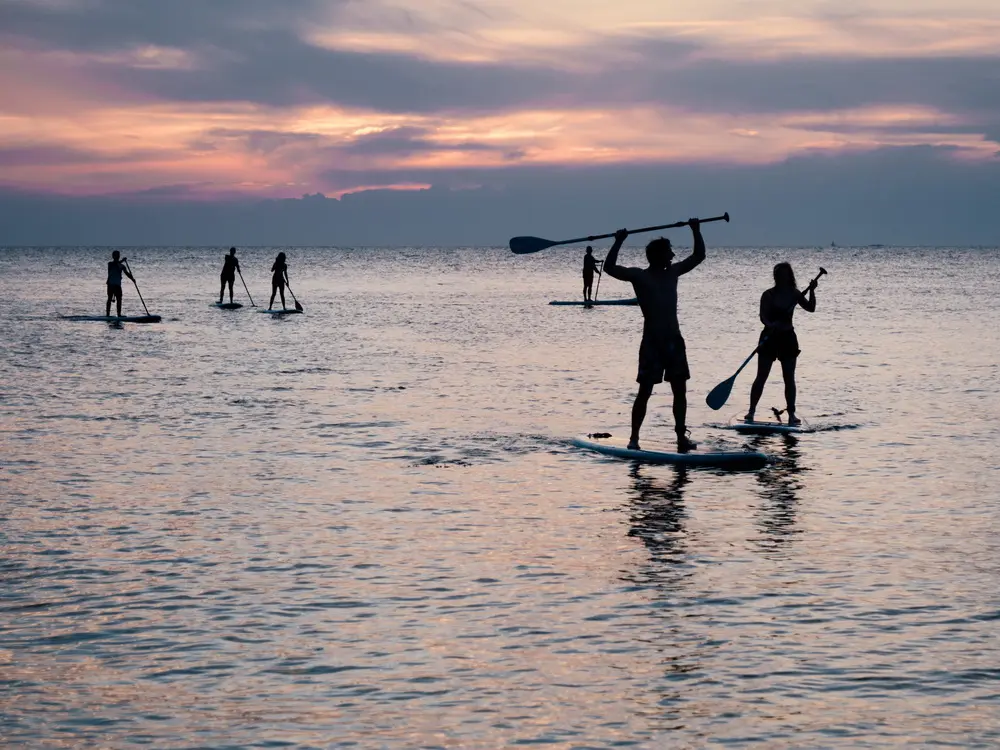 Stand-up paddleboarding in North Devon at sunset