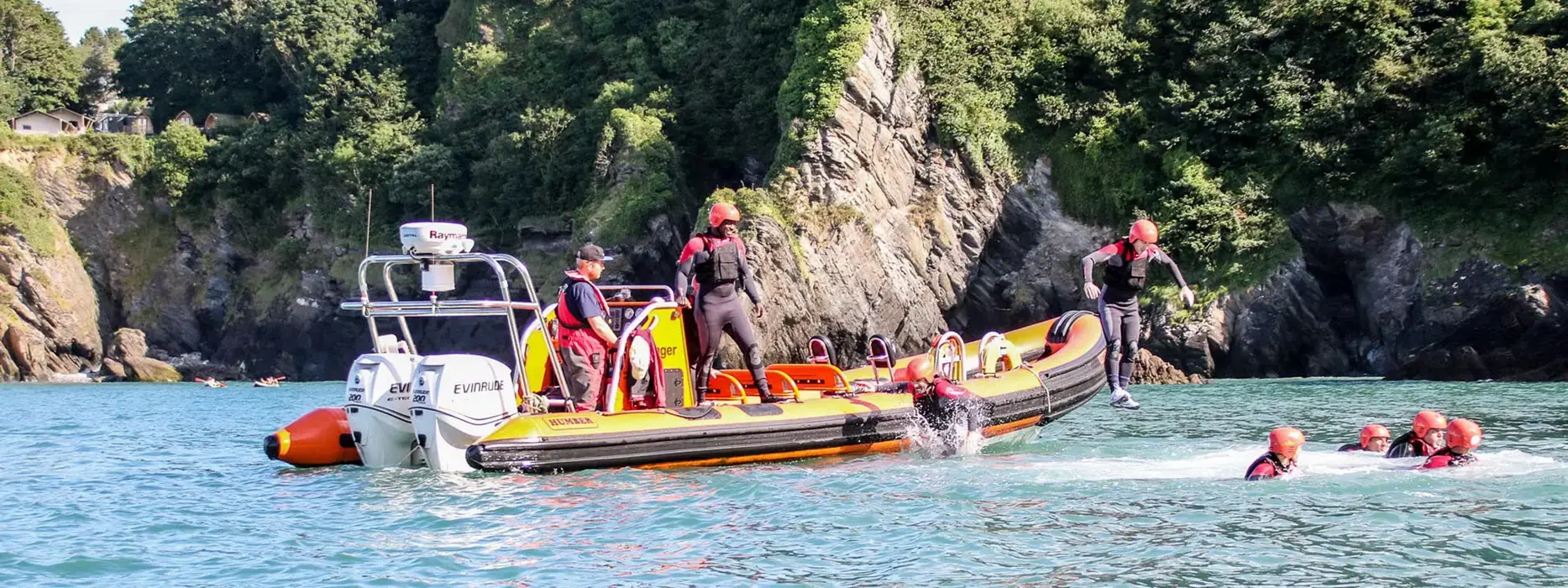 Coasteering group exploring the sea around Baggy Point at Croyde Bay